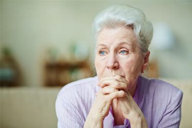 Senior woman with sad, thoughtful expression on her face