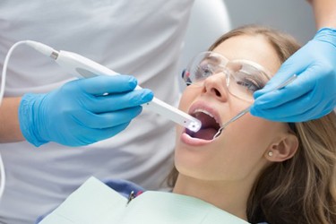 Woman dental exam with intraoral camera