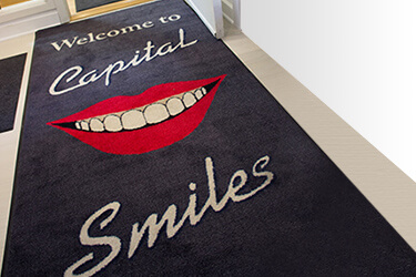 Floor rug that says welcome to Capital Smiles