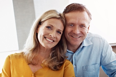 Smiling couple after visiting Capital District's trusted emergency dentist