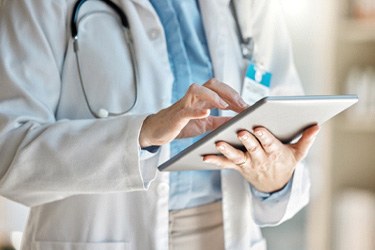 Medical professional holding a tablet