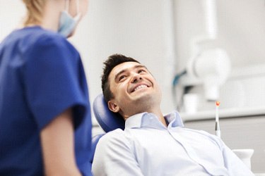 Dental patient smiling at his dentist