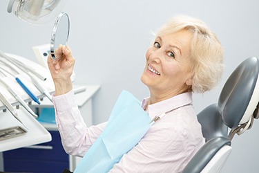 Senior female patient enjoying benefits of stabilized dentures