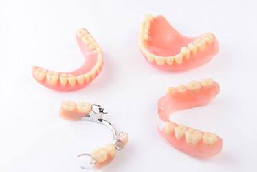 Full and partial dentures against neutral background