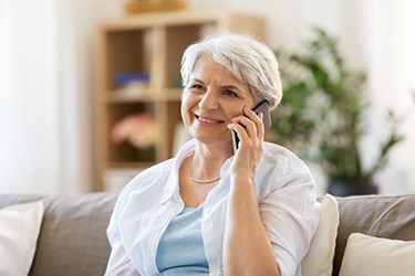 Happy, mature woman talking on phone