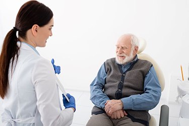 Dentist speaking with senior patient