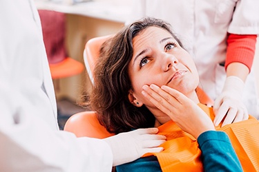 Emergency dental patient learning about the cost of her treatment