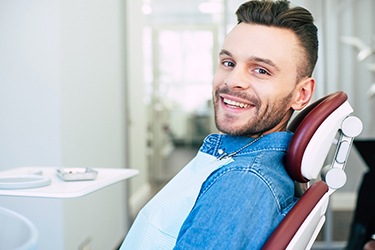 Happy male dental patient at cleaning and checkup appointment