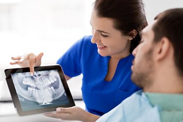 Dentist and patient discussing treatment details