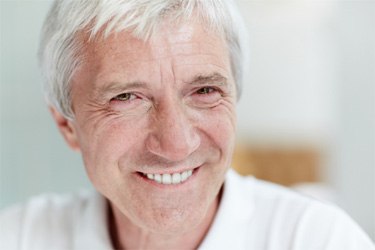 Smiling senior man enjoying the benefits of implant dentures