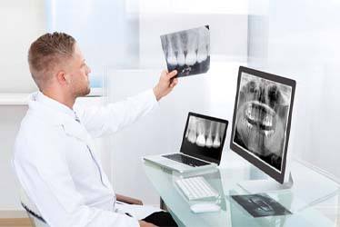 Schenectady implant dentist looking at X-rays