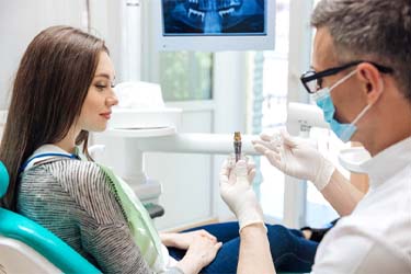Schenectady implant dentist showing patient model dental implant