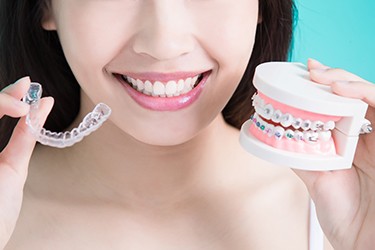 Woman comparing Invisalign vs other orthodontic treatments Schenectady