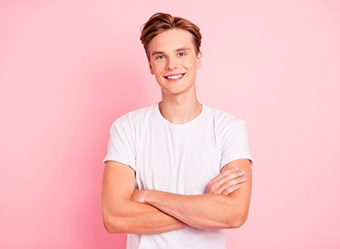 Teen boy in white shirt, candidate for Invisalign