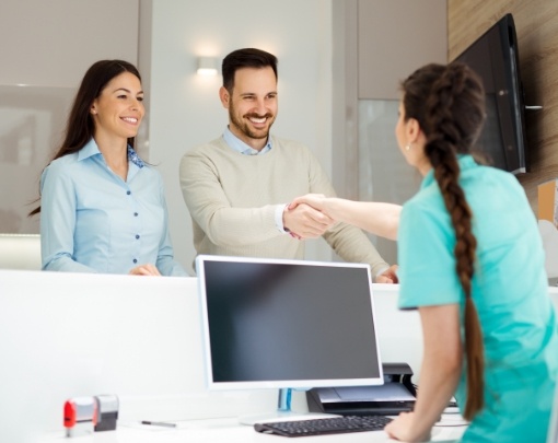 patients shaking hands with receptionist
