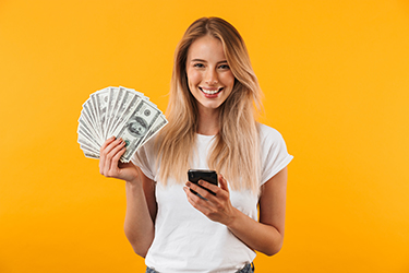 Smiling woman holding money