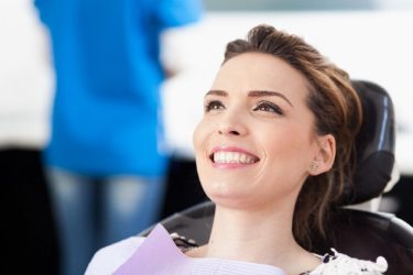 Married couple with perfect teeth after Capital District Smile Makeover