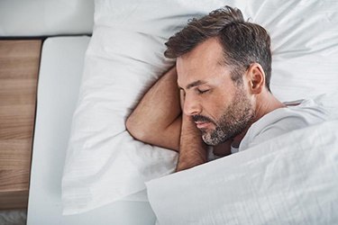 Man in bed resting