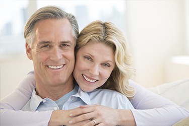 Married couple with perfect teeth after Capital District Smile Makeover