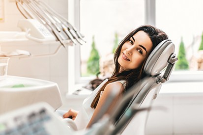 Happy woman in dental chair