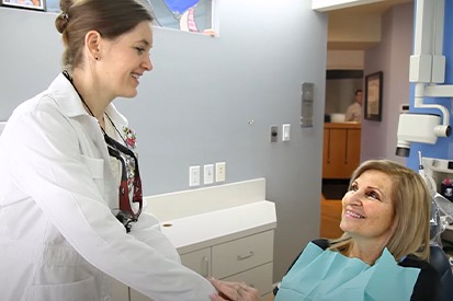 dentist talking to smiling patient
