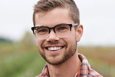 Smiling young man with glasses