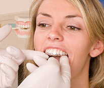 Dentist placing Invisalign tray for patient