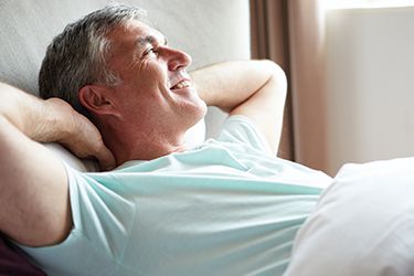 Man relaxing in bed