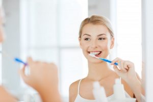 woman brushing teeth