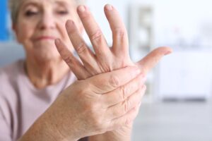 Woman suffering from the aches and pains of rheumatoid arthritis 