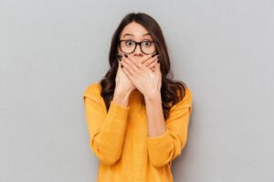 Shocked woman covering her mouth 