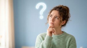 Frowning woman with question mark next to her head 