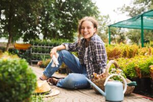 Happy woman sitting in her garden 