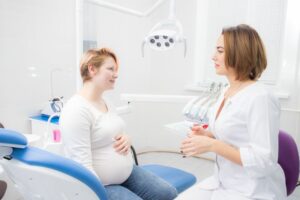 Pregnant patient talking with her dentist