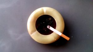cigarette sitting on an ash tray 