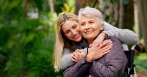 Woman embracing her senior mother