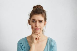 Concerned woman, wondering if she should visit a dentist for facial swelling