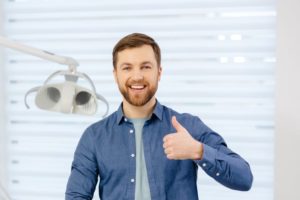 Male dental patient making thumbs up gesture