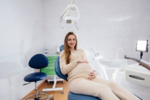 Pregnant dental patient reclining in treatment chair