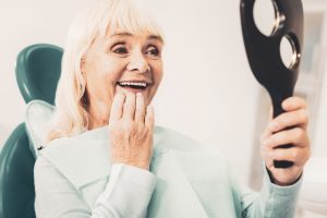 happy dental patient with mirror